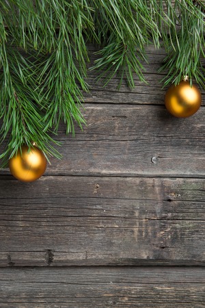 Yellow christmas tree baubles on old wooden table.の写真素材