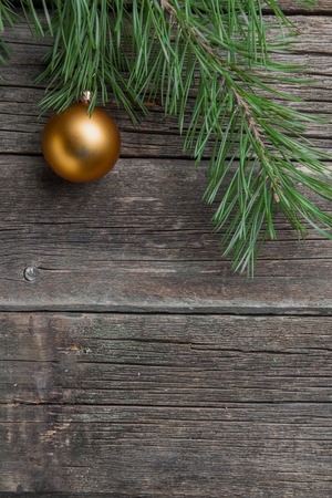 Yellow christmas tree bauble on old wooden table.の写真素材