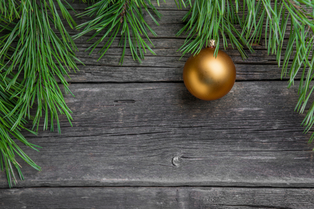 Yellow christmas tree bauble on old wooden table.の写真素材
