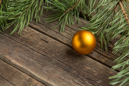 Yellow christmas tree bauble on old wooden table.の写真素材