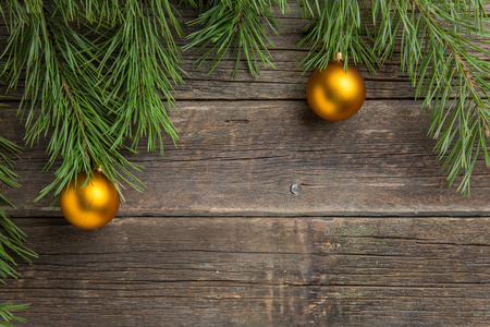 Yellow christmas tree baubles on old wooden table.の写真素材