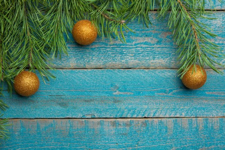 Golden Christmas baubles decoration on bright blue background. Flat lay. Holiday concept.
