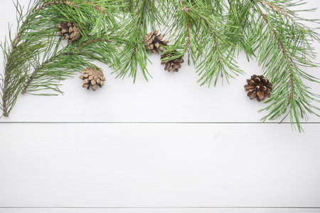 Christmas or New Year background with fir branches and cones flat lay, blank space for a greeting textの写真素材