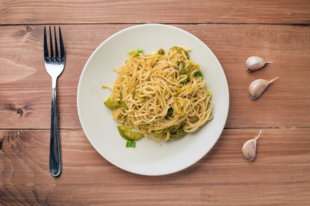 Asian noodles on plate on wooden table.の写真素材