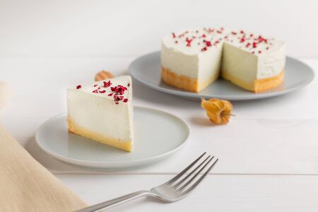 Cheesecake with matcha with dried berry on top on white backgroundの写真素材