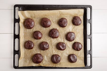 Chocolate Cookies In Tray Before Cooking In Oven on white wooden tableの写真素材