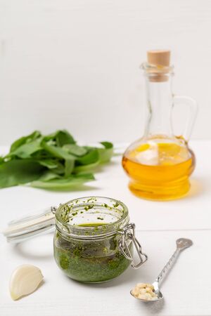 Pesto from fresh basil with pine nuts in a glass jar.の写真素材