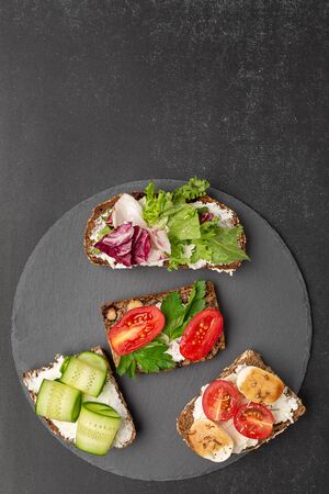 Variants of open sandwiches on rye bread for breakfastの写真素材