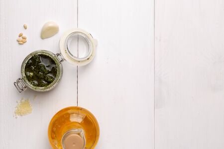 Jar with basil pesto sauce on table. Space for textの写真素材