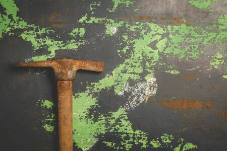 Old and scratched hammer on metal surface. Top view copy space, toned imageの写真素材