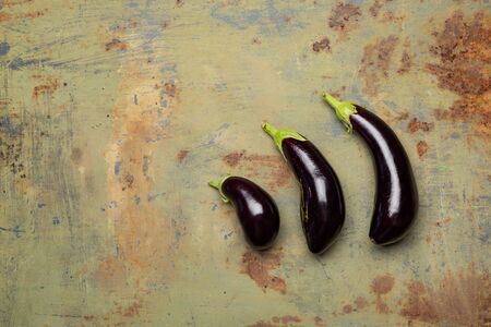 Fresh ripe eggplant On old metal background. Top view with copy spaceの写真素材