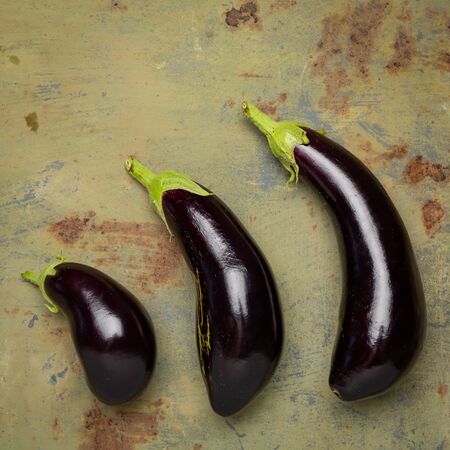 Fresh ripe eggplant On old metal background. Top view with copy spaceの写真素材