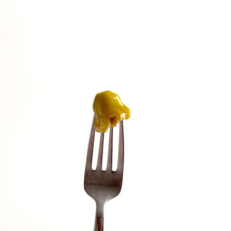 Marinated squash on fork on white backgroundの写真素材