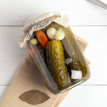 Pickled cucumbers closeup in a glass jar. Homemade vegetable canning.Top view. Square imageの写真素材