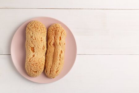 Homemade Eclair with craquelure on the plate on light background.の写真素材