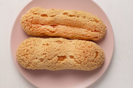 Homemade Eclair with craquelure on the plate on light background.の写真素材