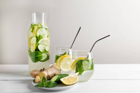 Sassy water slimming or infused water with lemon,mint, cucumber and ginger in glasses with metal tubes. Zero waste concept.の写真素材