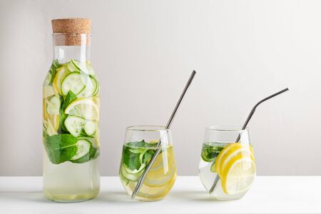 Sassy water slimming or infused water with lemon,mint, cucumber and ginger in glasses with metal tubes. Zero waste concept.の写真素材