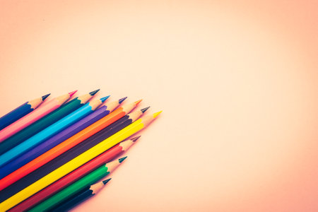 Many different colored pencils and on pastel pink background. Tonned imageの写真素材
