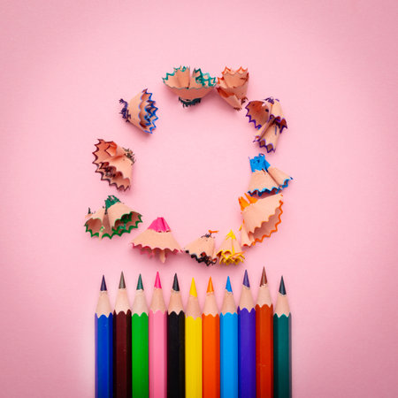 Many different colored pencils and shavings on pastel pink backgroundの写真素材