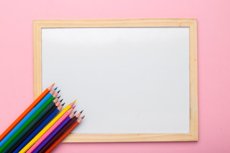 Colorful pencils near empty white frame. Education conceptの写真素材