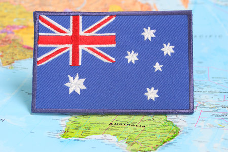 Australian embroidered flag on world map at Canberra. Concept for Earth Day, climate change awareness, national day and sustainable lifestyle , travel conceptの写真素材
