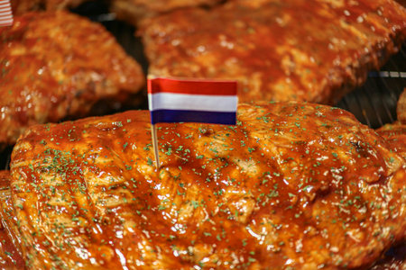 Close up BBQ ribs with red sauce and oregano, grilled over charcoal, tasty smoky street food look.の写真素材