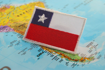 The national flag of Chile on a map Embroidered eco friendly Chile flag on map marking Santiago. Ideal for travel, national celebrations, cultural pride and sustainable conceptsの写真素材
