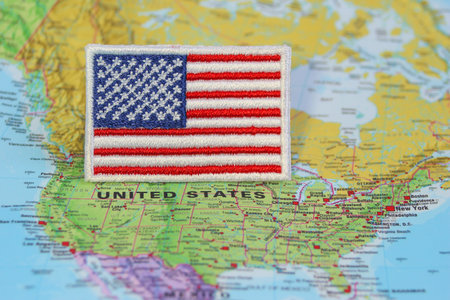 United States of America flag on the map Natural fiber embroidered USA flag on world map marking Washington DC. Concept for travel, national pride American heritageの写真素材