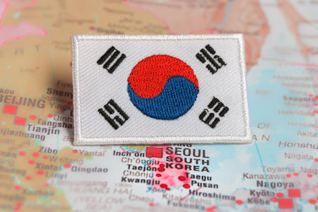 Flag of Republic of Korea on the map South Korea national flag KR flag embroidered on fabric, placed over Seoul South Korea map. Represents cultural travel and patriotism.の写真素材