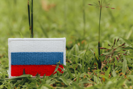 Russia flag on grass. Handmade eco Russia flag on grass, fabric and thread design. Green concept reflecting earth day, climate change and sustainability.の写真素材