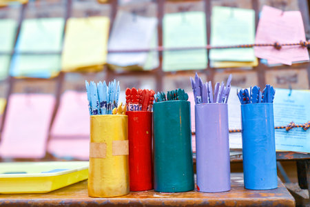 Five pastel fortune sticks before an old Thai prediction board. Used for traditional destiny reading ritual in Thai culture.の写真素材