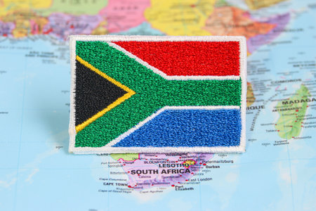 Eco friendly stitched South African flag made from fabric & thread, laid on a world map highlighting South Africaâs position in Africa. Great for travel,nature & Earth Day themes.の写真素材