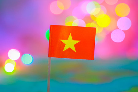 Vibrant Vietnam flag with bokeh background symbolizing national unity, travel spirit, and festive celebrations. Great for tourism and cultural promotions.の写真素材