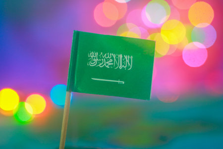Saudi Arabian flag with bright bokeh background. Reflects pride, identity, eco-tourism, cultural celebration, and vibrant unity in Middle Eastern festive atmosphere.の写真素材