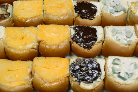 Hot steamed buns filled with chocolate, butter sugar, and taro cream, served in a steaming tray....