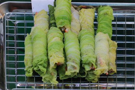 Fusion Thai shabu rolls with pork and crab stick wrapped in crisp cabbage, styled on a rack. A street food favorite blending tradition and modern flavors.の写真素材