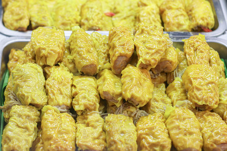 Traditional Thai shumai dumplings with pork and enoki mushrooms, wrapped in golden wonton skins, classic dim sum and street food delight.の写真素材