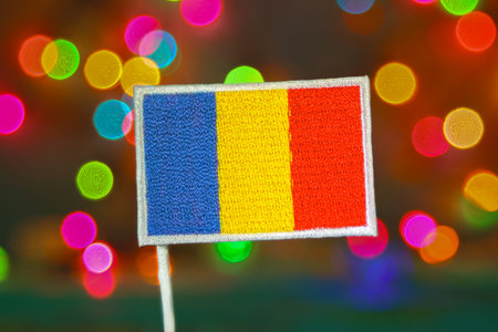 Romania embroidered flag with multicolor bokeh fireworks, festive concept of national pride, Christmas, and New Year holiday celebrations.の写真素材