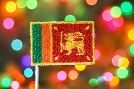 Sri Lanka embroidered flag with colorful bokeh fireworks, festive concept of national pride, New Year celebration, and holiday spirit.の写真素材