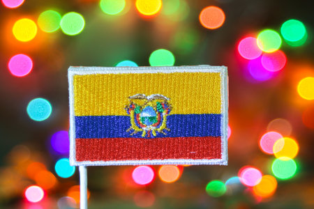 Ecuador flag embroidery with colorful bokeh resembling fireworks, symbolizing holiday celebrations, national pride, Independence Day, and vibrant New Year spirit.の写真素材