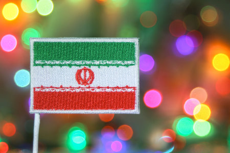 Iran embroidered flag with rainbow bokeh resembling fireworks, representing New Year celebration, national holiday, and patriotic pride in Tehran.の写真素材