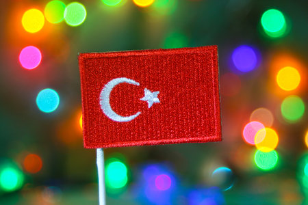 Turkey national flag embroidery with colorful bokeh fireworks background, symbolizing New Year celebration, patriotic pride, and festive national holiday.の写真素材