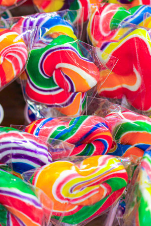 Rainbow lollipops in heart and star shapes with bright colors. Sweet playful candy perfect for children, parties, and festive occasions.の写真素材