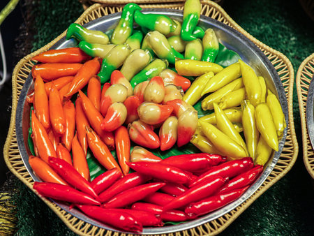 Colorful, handmade peppers coated with glossy glaze.