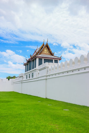 Vertical view of Wat Phra Kaew wall and Thai pavilion at the Grand Palace, Bangkok. White fortress...