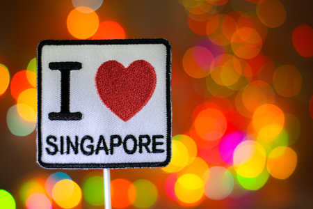 Eye-catching patch with a sewn finish, on a background of luminous, multi-colored bokeh lights. Ideal for travel, New Year, and holiday visuals.の写真素材