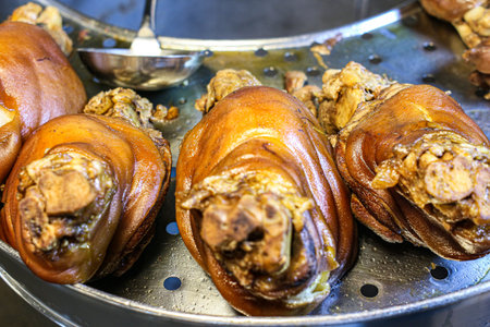 Traditional Thai Braised Pork Leg (Stewed Pork) on a metal tray. The tender texture and rich, savory sauce represent the best of Thai street food culture.の写真素材
