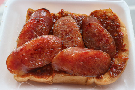Thai Chili Paste Toast topped with caramelized Lap Cheong slices. A delicious, authentic Thai street snack combining sweet, savory, and spicy notes.の写真素材
