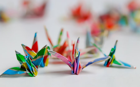 Close-up of multi-colored origami paper cranes with soft blur. Highlights the Japanese craft and symbol of peace/hope. Perfect for education and travel content.の写真素材